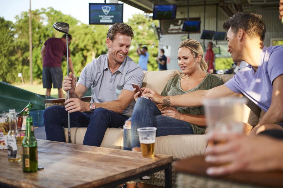 group of people socialising using toptracer by top golf